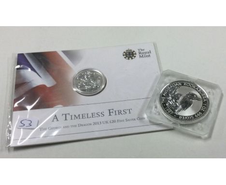 A silver 1 oz coin together with a 'Timeless First' Proof silver coin.