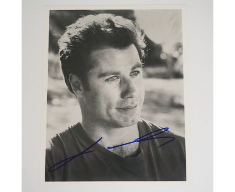 Striking black-and-white autographed photograph of John Travolta, the award-winning actor known for iconic roles in Saturday 
