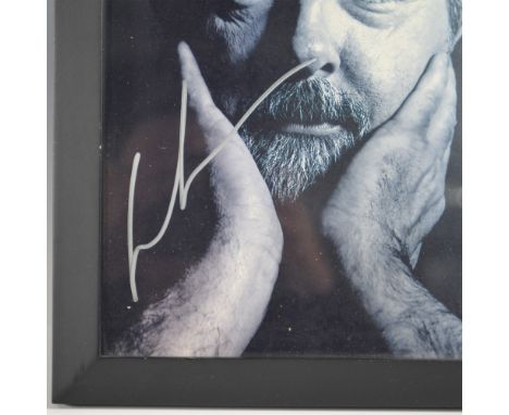 A striking George Lucas signed photograph, featuring a contemplative black-and-white portrait of the legendary filmmaker. The