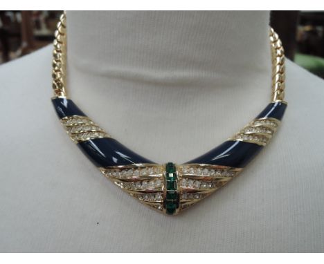 A 1980's necklace by Grosse having flat link chain with central V shaped panel having blue enamel with green and diamante pas