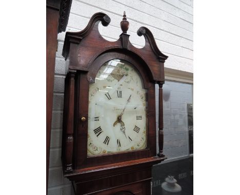 An early 19th century mahogany long case clock having swan neck and pillar hood containing arched painted dial and 30hour mov
