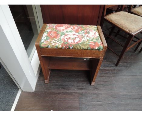 A mid 20th century Arts & Crafts style golden oak stool having handcrafted floral tapestry upholstery
