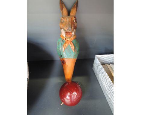 A vintage continental painted treen toy rabbit and a circular timer
