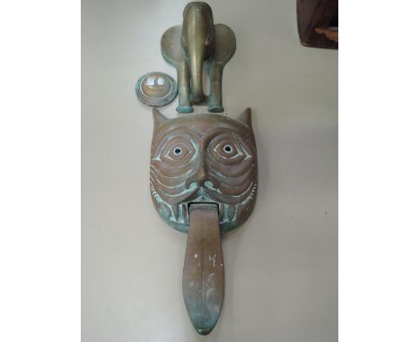 A copper door knocker modelled as a fox's head and a brass door knocker modelled as an elephant's head