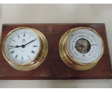 A modern ship's style brass quartz clock and aneroid barometer mounted on mahogany plinth