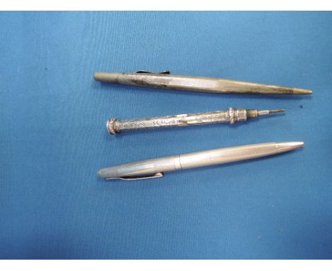 A white metal retractable pencil of hexagonal form having scroll decoration and intaglio seal to knop, an HM silver cased pen