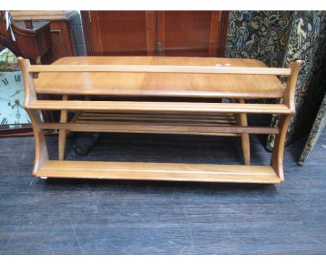 A late 20th century light/medium Ercol wall mounted shelf rack