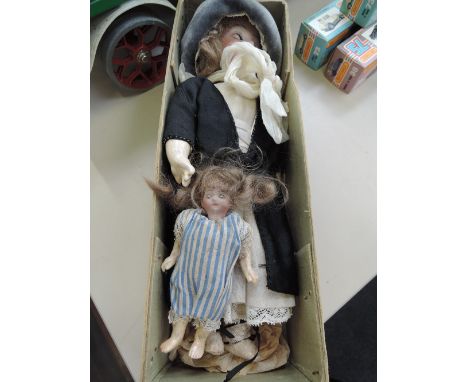 A late 19th/early 20th century German bisque headed doll having sleep eyes, open mouth with six teeth showing and composition
