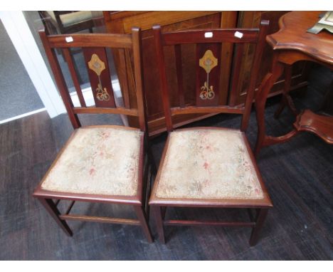 A pair of early 20th century mahogany bedroom chairs having Art Nouveau inlay decoration