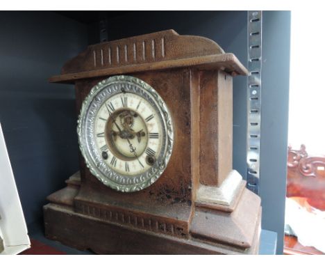 A late Victorian metal frame mantel clock in the architectural style