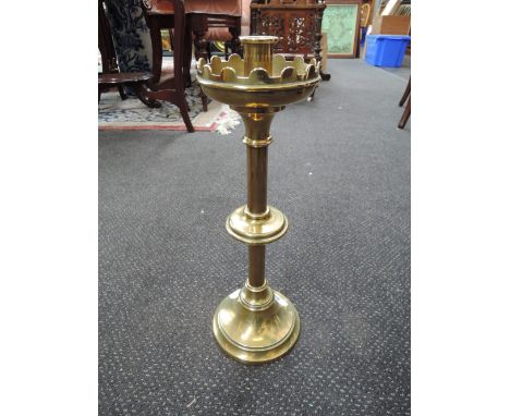 A 19th century brass candlestick of ecclesiastical design and a stainless steel Firth-Keswick School of Industrial Art oval t