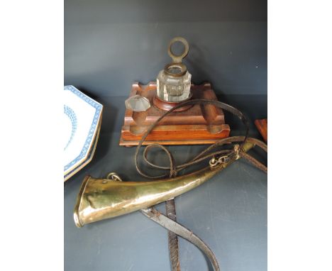 A vintage brass hunting horn stamped Hirsbrau on leather strap, and an Edwardian oak and glass ink stand