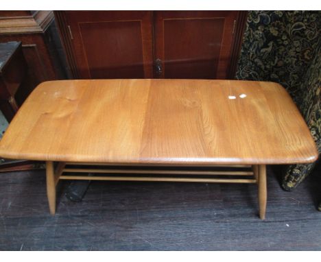 A late 20th century light/medium Ercol coffee table, having slat undertier on tapered legs