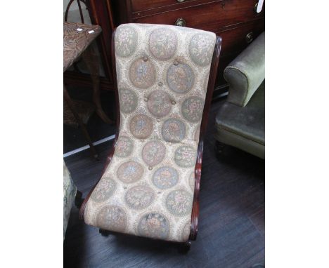 A reproduction Victorian style mahogany nursing chair on shaped and turned frame with tapestry upholstery