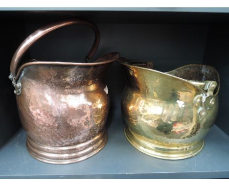 An early 20th century copper coal scuttle of helmet form a similar brass scuttle and a spokeshave