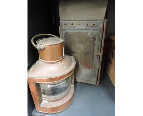 A copper lamp of maritime form and a coloured glass lantern of railway form