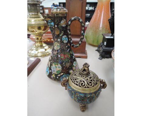A cloisonne jug of Eastern design having typical decoration on black ground and an Eastern brass lidded incense jar on trefoi