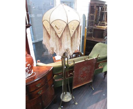 An early 20th century brass standard lamp, of Art Nouveau style, having triple splay frame, central column and period shade