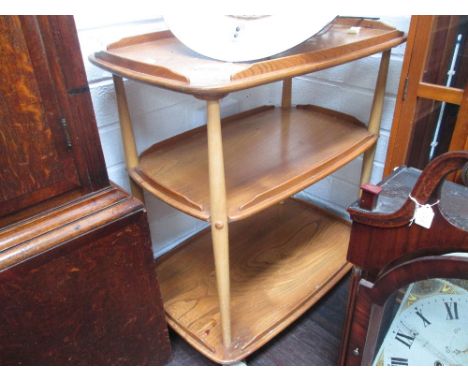 A late 20th century llight/medium Ercol tea trolley, having three tiers on tapered supports