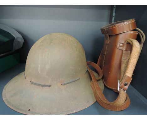A Second World War era military helmet and a pair of vintage binoculars