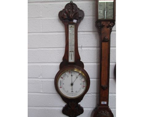 A late Victorian oak case banjo barometer having carved crest and thermometer scale