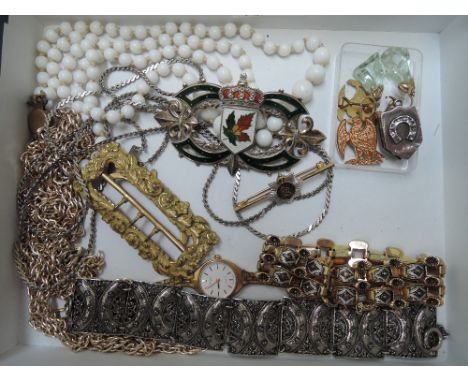 A selection of costume jewellery including a gilt buckle having moulded floral decoration, a Canadian white metal and enamel 