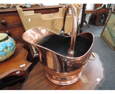 A late Victorian copper coal scuttle of helmet form