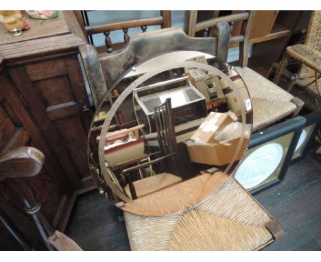 A circular peach wall mirror in the Art Deco style