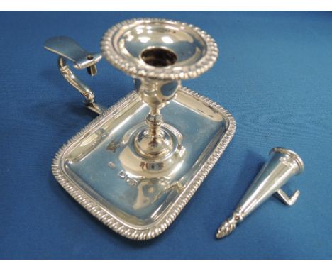 A small silver chamber stick on rectangular base having gadrooned decoration with snuffer, London 1899 & 1900