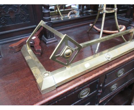 A late Victorian brass fire kerb of Art Nouveau design