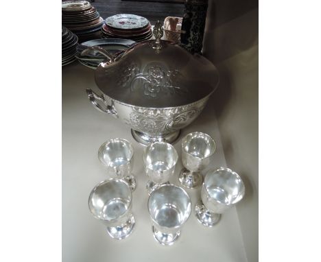 A silver plated lidded punch bowl with ladle, by Cavalier having floral decoration with plain cartouche and six matched plate