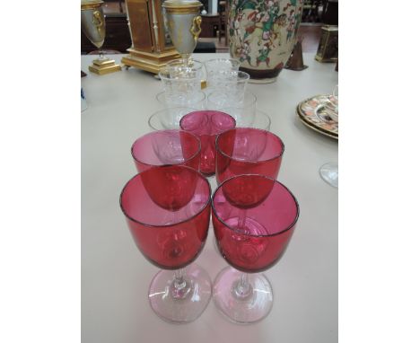 A selection of glassware including art glass tumblers and cranberry wine glasses
