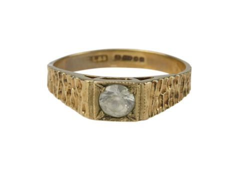 A 9ct gold ring - set with a cubic zirconia stone between textured shoulders, size O, 2g.