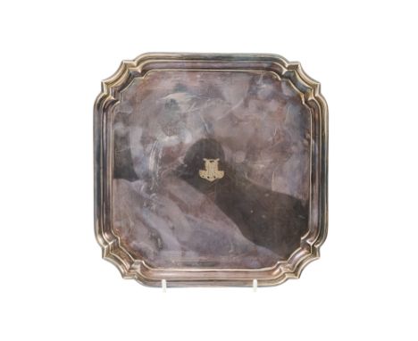 A silver waiter - Sheffield 1932, square with cusped corners and raised on lug feet, 475g.