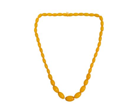 A butterscotch amber style necklace - of graduated, torpedo shaped beads, length 58cm.