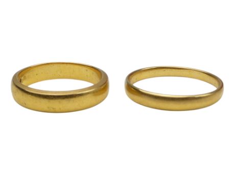 A 22ct gold wedding band - size K, together with another size O, 7.2g.