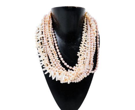 A multi-strand pearl necklace - of uniform and asymmetric beads and magnetic silver clasp, 55cm long.