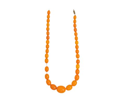 A golden amber style necklace - of graduated oval shaped beads, length 46cm.