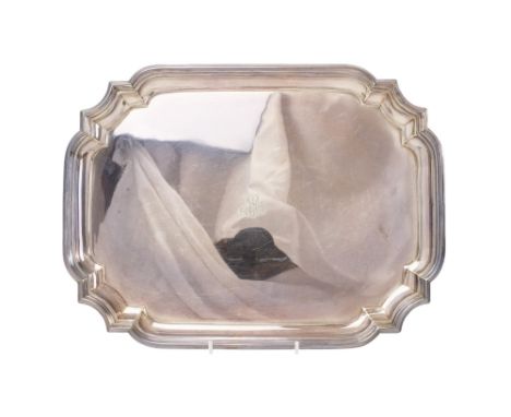 A rectangular silver tray - Sheffield 1931, with cusped corners and raised on lug feet, 1,165g.