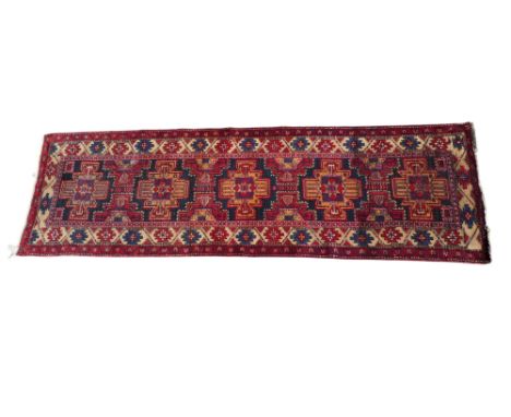 A Heriz runner - with medallions on a blue ground and stylised flowerhead border, 134 x 98cm.
