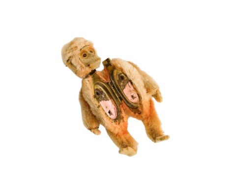 A Schuco orange plush novelty ladies powder compact - modelled in the form of a monkey with jointed limbs, 8cm.