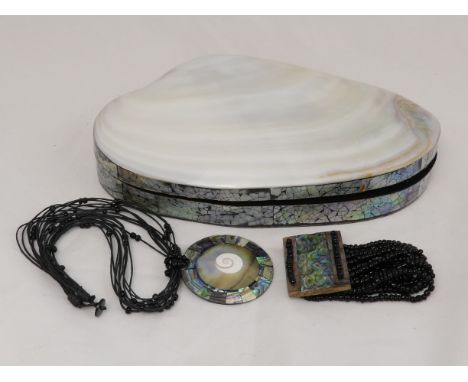 An asymmetrical jewellery box - fashioned from a polished pearl shell, 26cm wide, together with a shell necklace and a simila