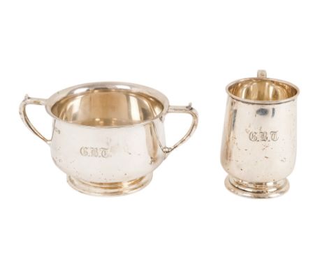 A silver twin handle cup - Birmingham 1928, engraved with initials and raised on a foot, together with a christening cup, 306