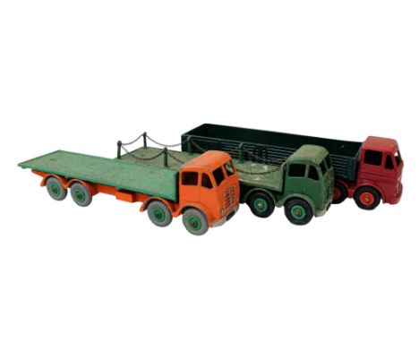 A Dinky Supertoys Foden flatbed truck - green, together with a similar orange example and a Layland Octopus. (3)