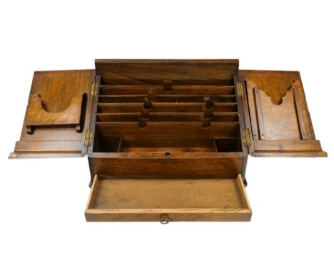 An early 20th century oak stationery casket - the doors opening to revealing a fitted interior above a drawer, 40cm wide