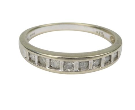 A 9ct white gold diamond set ring - channel set with eight stones size Q, 2.3g.