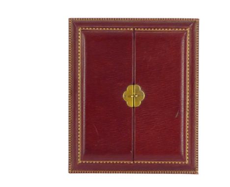 An early 20th century red Morocco leather travelling photograph frame - easel type with gilt tooling and hinged doors, apertu