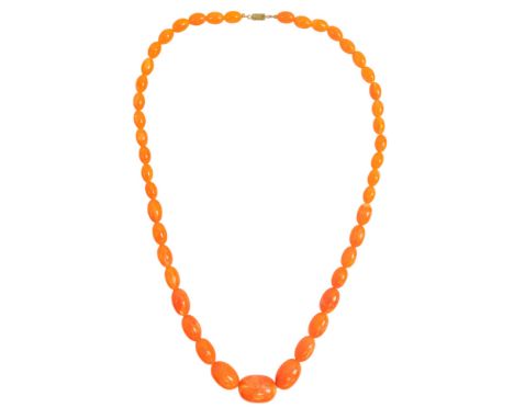 A golden amber style necklace - of graduated, torpedo shaped beads, length 72cm.