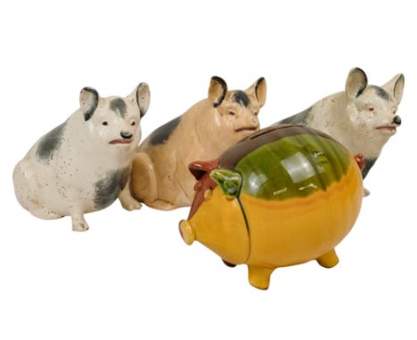 A Whieldon style pottery pig money box - in brown, green and yellow glazes 13cm high, together with three further pig money b