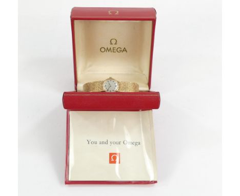 A vintage Omega ladies wristwatch - the silver dial set out with Arabic numerals on an integral mesh strap, 28.5g all in, pre